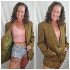 May include: A brown plaid blazer with a single-button closure and two front pockets. The blazer has a green lining with a floral pattern. The blazer is a classic style, suitable for various occasions.