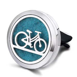 May include: Silver car air freshener with a blue felt pad and a cut-out design of a bicycle.