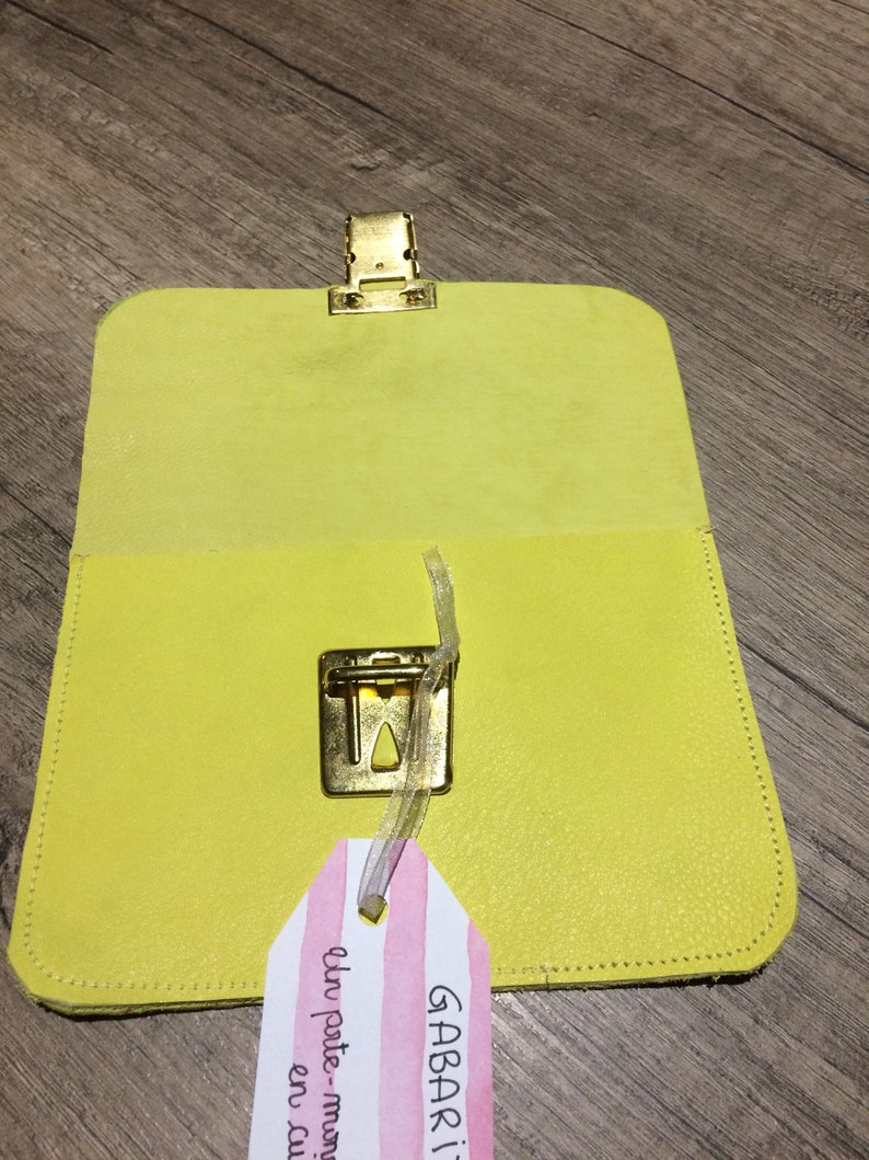Yellow leather wallet and scales
