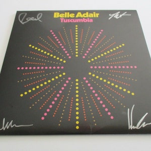 May include: Black vinyl record with a colorful dot pattern. The record is signed by Belle Adair, Tuscumbia, and three other people.