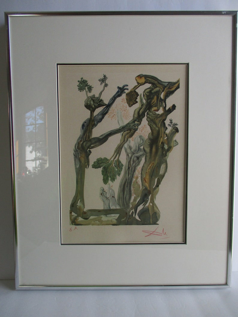 May include: A framed print of a surrealist artwork depicting two figures intertwined with tree branches. The artwork is in shades of green, brown, and white, with a red signature in the bottom right corner. The print is numbered "E.A."