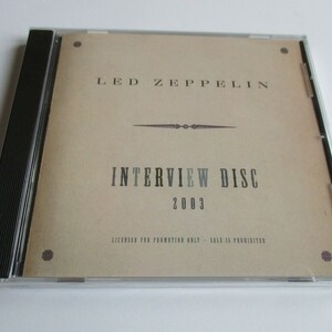 May include: A beige CD case with a black spine. The front of the case features the text "LED ZEPPELIN INTERVIEW DISC 2003" in black lettering. The text "LICENSED FOR PROMOTION ONLY - SALE IS PROHIBITED" is printed in smaller black lettering at the bottom of the case.