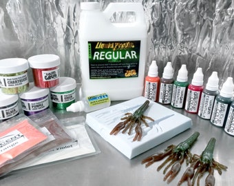 May include: A set of craft supplies for making fishing lures, including liquid plastic, glitter, colorants, and a mold for a crawfish lure. The set also includes a bottle of pure and unscented oil. The text on the bottle of liquid plastic reads "Liquid Plastic Regular Formula".