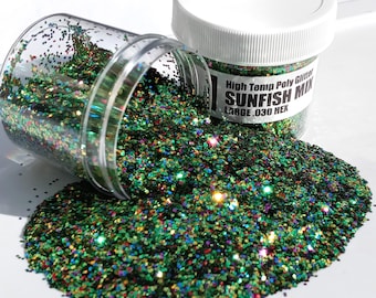 May include: A clear plastic jar filled with green, black, red, and gold glitter. The jar is tipped over, spilling the glitter onto a white surface. The label on the jar reads "High Temp Poly Glitter Sunfish Mix Large .030 Hex".