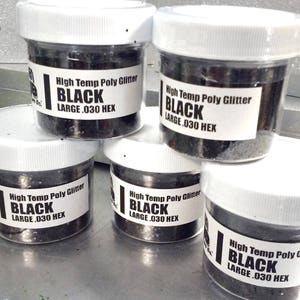 May include: Five jars of black high temperature poly glitter, each labeled "High Temp Poly Glitter Black Large .030 Hex".
