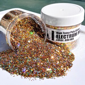 May include: A jar of gold, copper, and iridescent glitter labeled "High Temp Poly Glitter ELECTRUM MIX LARGE .030 HEX". The glitter is spilling out of the jar onto a white surface.