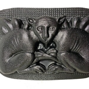 May include: Black plastic mold of two animals, possibly squirrels, facing each other with their paws touching. The mold is textured and has a grid pattern on the back.