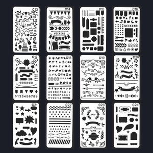 May include: A collection of twelve white plastic stencils for crafting and journaling, each with a unique design. The stencils include shapes, banners, arrows, and text, such as "Party" and "Weekend". The stencils are arranged in a grid against a dark background.
