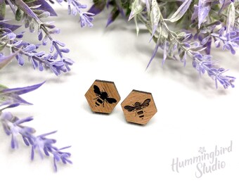 Walnut wood hexagon shaped post earrings with small honey bee design