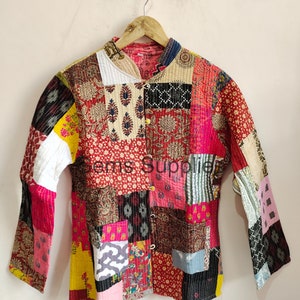 May include: A colorful patchwork quilted jacket with a mandarin collar and button closure. The jacket is made of various fabrics in shades of red, pink, yellow, blue, and green.