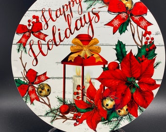 Könnte beinhalten: Rundes weißes Holzschild mit dem Text "Happy Holidays" in roter Kursivschrift. Das Schild zeigt eine rote Laterne mit einer goldenen Schleife und Glocken, eine rote Weihnachtsstern-Blume und grüne Stechpalmenblätter.