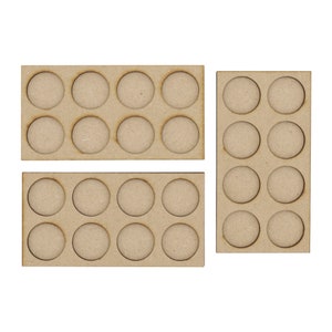 May include: Three wooden paint pot trays with circular cutouts. The trays are brown and have a total of 18 cutouts.