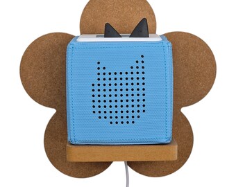 May include: A blue fabric speaker with a cat-shaped speaker grille mounted on a wooden flower-shaped wall mount.