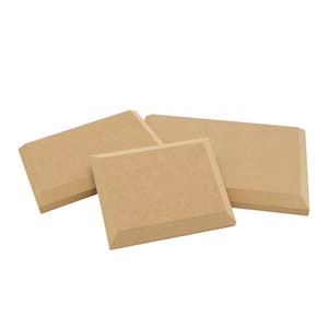 May include: Three beige acoustic foam panels with bevelled edges. The panels are arranged in a triangular shape.