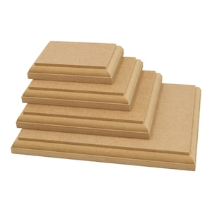 May include: A set of five wooden display risers, stacked in descending size, with a light brown finish. The risers have a slightly rounded edge and are ideal for showcasing small items.