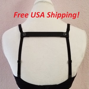 May include: Black bra strap converter with adjustable straps and black buttons. The converter is shown on a white mannequin. Free USA Shipping!