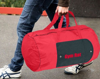 May include: A red duffel bag with a black zipper and a black patch that says "Gym Rat".