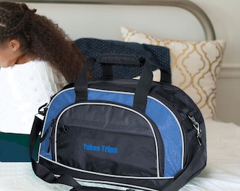 May include: A black and blue duffel bag with a zippered pocket and a shoulder strap. The bag has the text "Tahoe Trips" embroidered on the front.