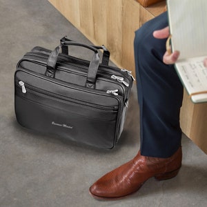May include: Black leather briefcase with a silver zipper and the text "Business Mindset" embossed on the front.