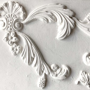 May include: White plaster moldings with intricate floral designs. The moldings feature a variety of leaves, flowers, and scrolls. The moldings are perfect for adding a touch of elegance to any room.