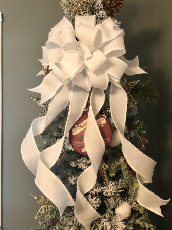 Discarded Christmas Tree With Bow Decoration Wrapped In A White
