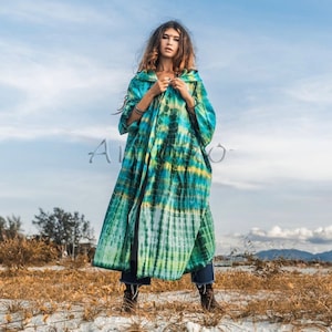 May include: A long, hooded, tie-dye robe in shades of green and blue. The robe is open in the front and has a tie at the waist.