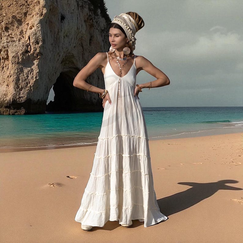 The Savita Beach Bridal Gown is a raw cotton maxi dress that blends bohemian soul with minimalist luxury. Its deep neckline, smocked stretch-back, and tiered silhouette make it a flattering, comfortable fit for every body. Perfect for beach engagements, summer weddings, or maternity celebrations, this unlined, breathable dress invites movement, meaning, and magic into your most treasured moments under the sun.