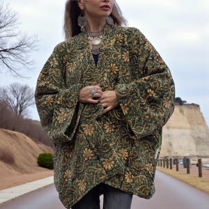 Close-up detail of green and gold velvet floral kimono jacket showing intricate artisan pattern, soft texture, and handmade craftsmanship — vintage-inspired boho fashion by ZinniaPearl.