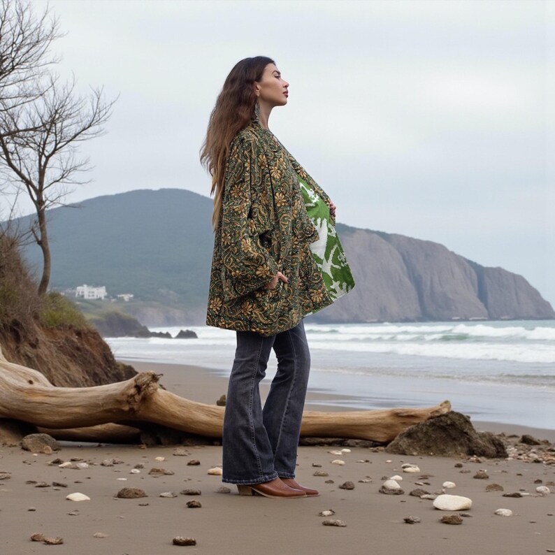 Side profile of model in green floral embroidered kimono jacket with contrast printed lining, wide sleeves, and relaxed fit — handmade boho outerwear by ZinniaPearl.