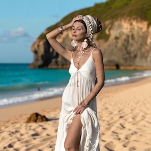 For the bride who walks barefoot and carries sacred intention, the Savita Boho Wedding Dress delivers ease, breathability, and timeless style. Crafted from 100% raw cotton and finished with a stretch back and adjustable straps, this ethereal tiered gown is perfect for warm-weather weddings, elopements, and conscious celebrations. Flowing and unlined, it honors simplicity and beauty in every stitch—handmade and designed to move with grace.