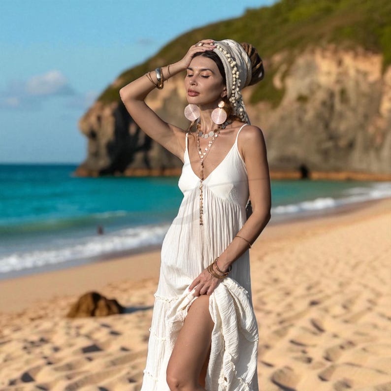 For the bride who walks barefoot and carries sacred intention, the Savita Boho Wedding Dress delivers ease, breathability, and timeless style. Crafted from 100% raw cotton and finished with a stretch back and adjustable straps, this ethereal tiered gown is perfect for warm-weather weddings, elopements, and conscious celebrations. Flowing and unlined, it honors simplicity and beauty in every stitch—handmade and designed to move with grace.