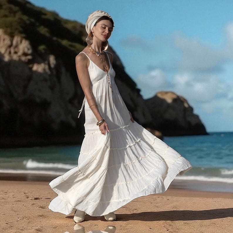 Let your ceremony be guided by soul, sun, and simplicity in this raw cotton boho wedding gown. The Savita Dress flatters with a smocked back and adjustable ties, while its tiered skirt offers effortless movement and natural grace. Lightweight and handmade, it’s perfect for beach weddings, yoga-inspired unions, or moonlit rituals. This elopement-ready dress channels sacred softness with a breathable, organic texture in a timeless neutral tone.