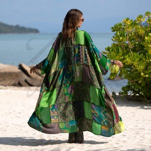 Back view of the Harper Jade Vintage Silk Kimono in Emerald Oasis colorway, highlighting the intricate patchwork of emerald, teal, and patterned silk squares. The robe’s flowing silhouette and wide sleeves create effortless movement, perfect for goddess-inspired styling at the beach, resort, or music festivals. A handmade, eco-conscious bohemian duster.