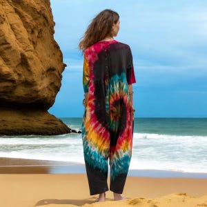 Curvy-friendly harem romper for summer made with sustainable materials. Jersey cotton tie-dye jumpsuit featuring coconut button closure, deep pockets, and artisan-made charm. A festival favorite and beach essential for the modern boho goddess seeking freedom and style.