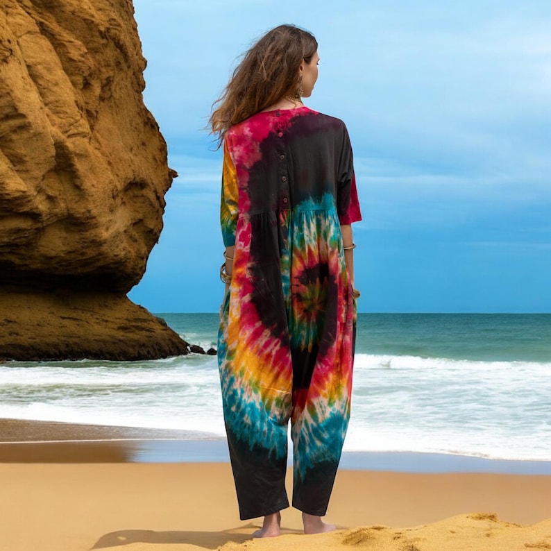 Curvy-friendly harem romper for summer made with sustainable materials. Jersey cotton tie-dye jumpsuit featuring coconut button closure, deep pockets, and artisan-made charm. A festival favorite and beach essential for the modern boho goddess seeking freedom and style.