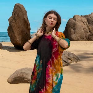 Flowy harem jumpsuit with boho energy, made for warm-weather adventures and soulful living. Hand-dyed in earthy jewel tones with wide-leg comfort and a flattering plus size fit. From music festivals to morning meditations, this tie-dye romper blends artistry with functionality.