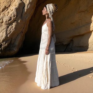 Step into your sacred “yes” in the Savita raw cotton wedding dress—a breezy, handcrafted gown for plus-size and petite boho brides alike. With its plunging neckline, stretch back, and tiered silhouette, this dress brings comfort and poetic movement to beach ceremonies, desert vows, or festival elopements. Made from breathable natural fabric, it’s perfect for those seeking slow fashion, ethical elegance, and goddess-inspired wedding wear.