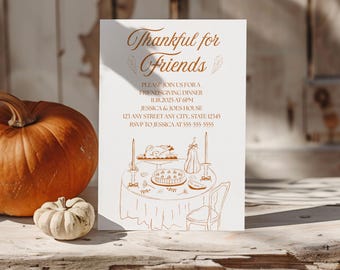 May include: A Thanksgiving invitation card with the text "Thankful for Friends" in elegant script. The card features a detailed illustration of a table setting with food and candles. A large orange pumpkin and a small white gourd are in the background.