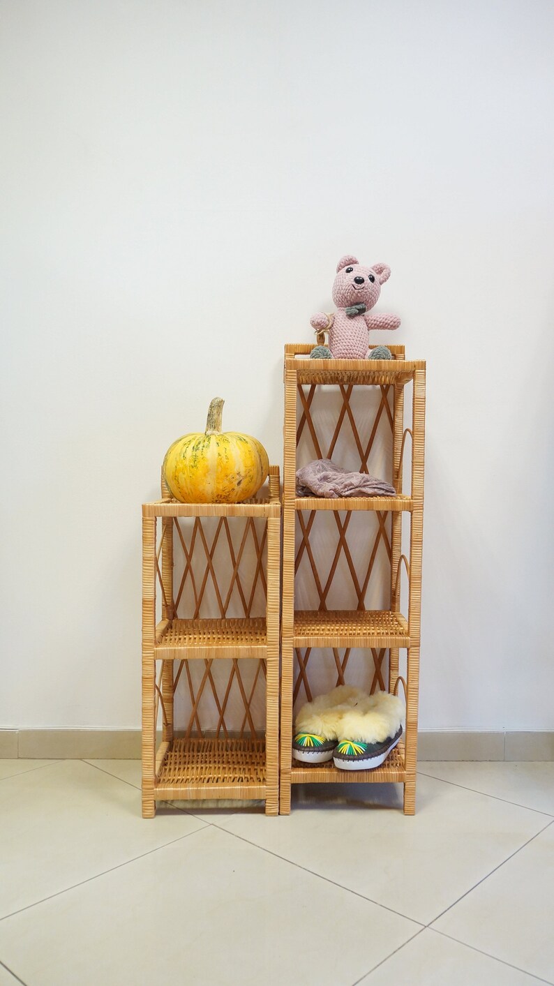 May include: Two wicker shelves with a pumpkin on the top shelf of the left shelf, a stuffed animal on the top shelf of the right shelf, and a pair of slippers on the bottom shelf of the right shelf.