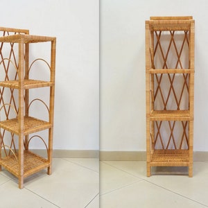 May include: A natural woven wicker shelf unit with four shelves. The shelf unit is made of natural woven wicker and has a light brown color.