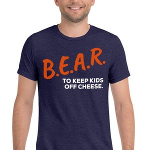 May include: A navy blue t-shirt with the text "B.E.A.R. TO KEEP KIDS OFF CHEESE." in orange lettering.