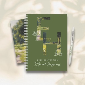 May include: A green spiral-bound notebook and a matching pen. The notebook has the text "2026 Convention Eternal Happiness" and a large "EH" design filled with a landscape image. The pen is white and has the words "Eternal Happiness".