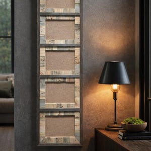 May include: A vertical wall-mounted picture frame with four rectangular openings. The frame is constructed from reclaimed wood, featuring a mix of natural wood tones and gray accents. The background of each opening is a neutral tan color. A black lamp with a black shade sits on a wooden table.