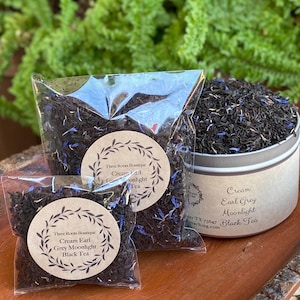 May include: Three sizes of loose leaf black tea blend called "Cream Earl Grey Moonlight" packaged in a clear plastic bag, a brown paper bag, and a silver tin. The label on the tin reads "Cream Earl Grey Moonlight Black Tea".