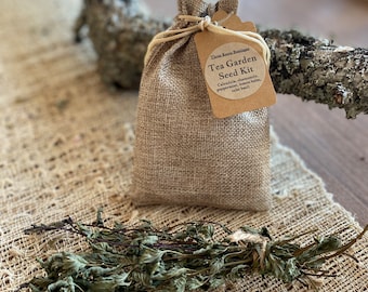 May include: A small burlap bag filled with tea garden seeds. The bag has a brown paper tag with the text "These Rasta Rustiga Tea Garden Seed Kit Calendula, chamomile, peppermint, lemon balm,  "