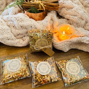 May include: Three clear plastic bags filled with different types of simmering potpourri. The bags are labeled "Herb & Orange Simmering Potpourri", "Orange Clot Simmering Potpourri", and "Sweet Forest Simmering Potpourri".