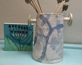 Decorative ceramic vessel with botanical stencils