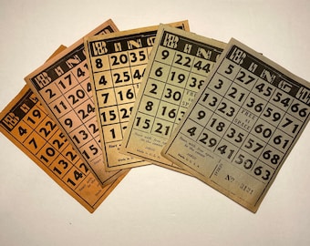May include: A collection of vintage bingo cards, each with a grid of numbers and the word "BINGO" at the top. The cards are printed in black ink on aged, tan paper. The cards are fanned out, showing the numbers and the "JARCO" brand.