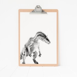 May include: A black and white illustration of a dinosaur on a clipboard with a brown frame.