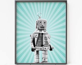 May include: A vintage silver robot toy with a blue and white striped background. The robot has a round head with large eyes and a small mouth.